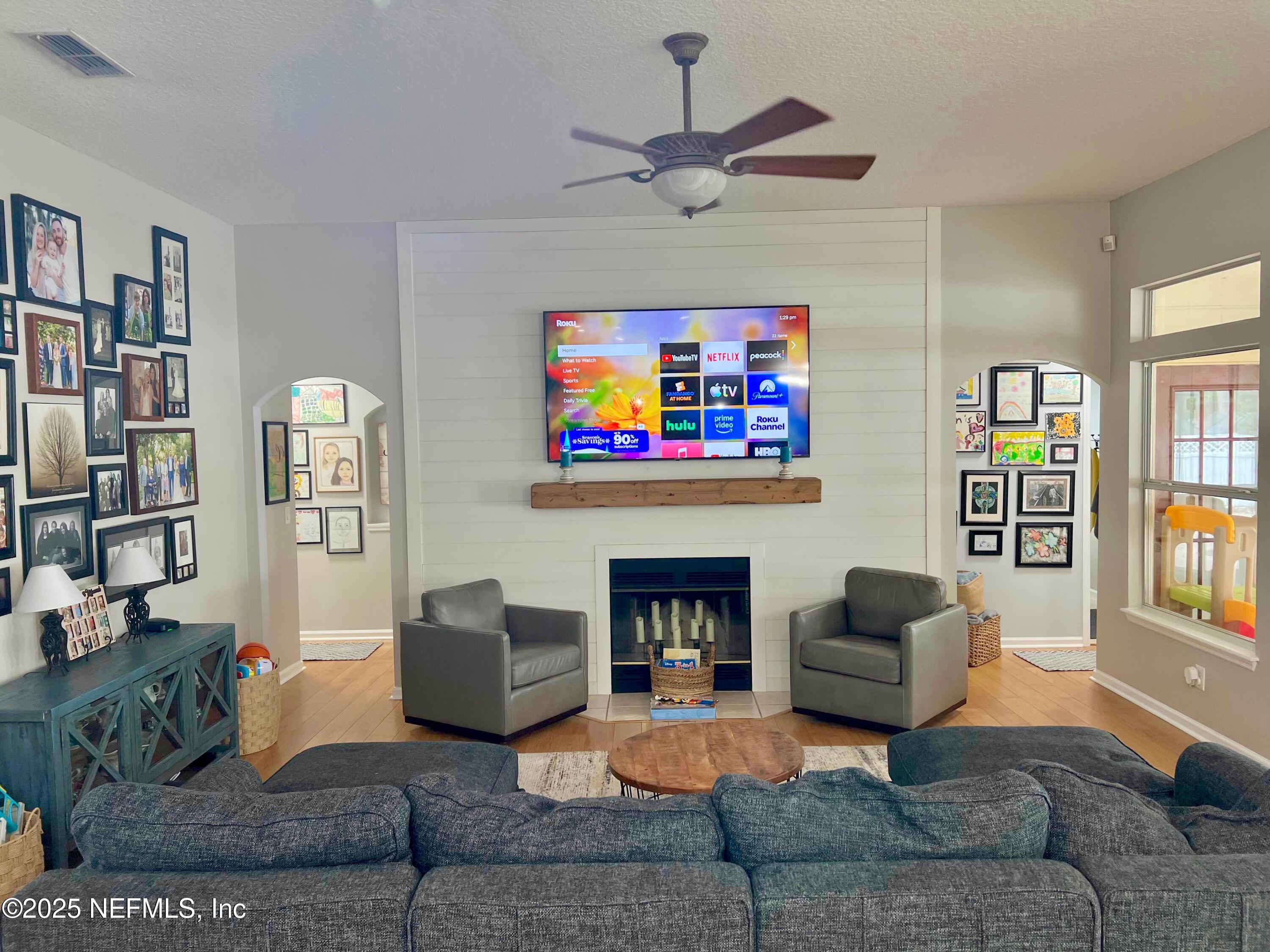 2020 Belle Grove Trace Fleming Island, FL 32003 - Photo 11 of 31 a living room with furniture a bookshelf and a window