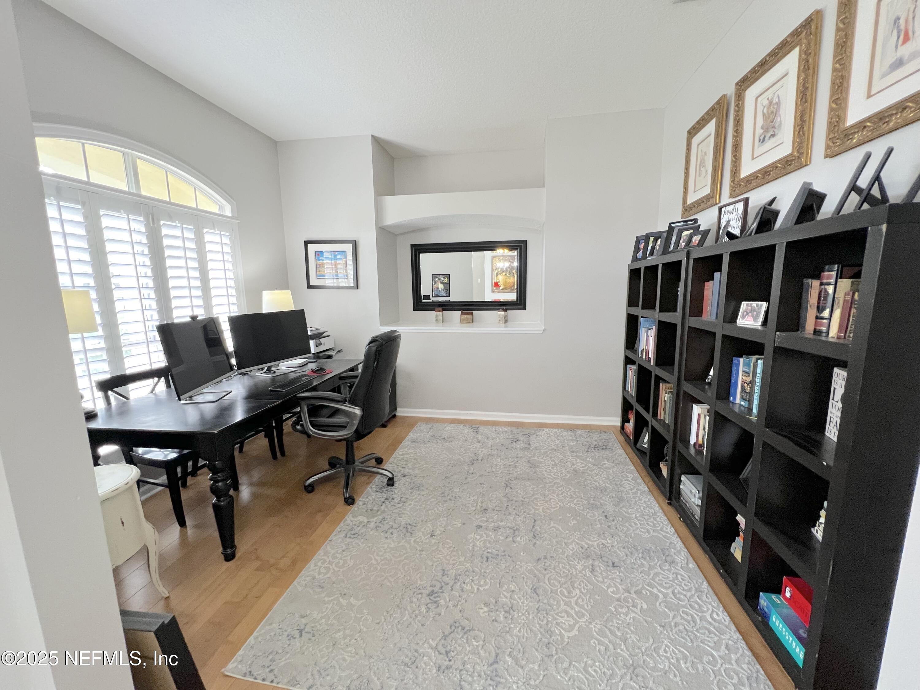 2020 Belle Grove Trace Fleming Island, FL 32003 - Photo 12 of 31 a view of a workspace with furniture and a large window