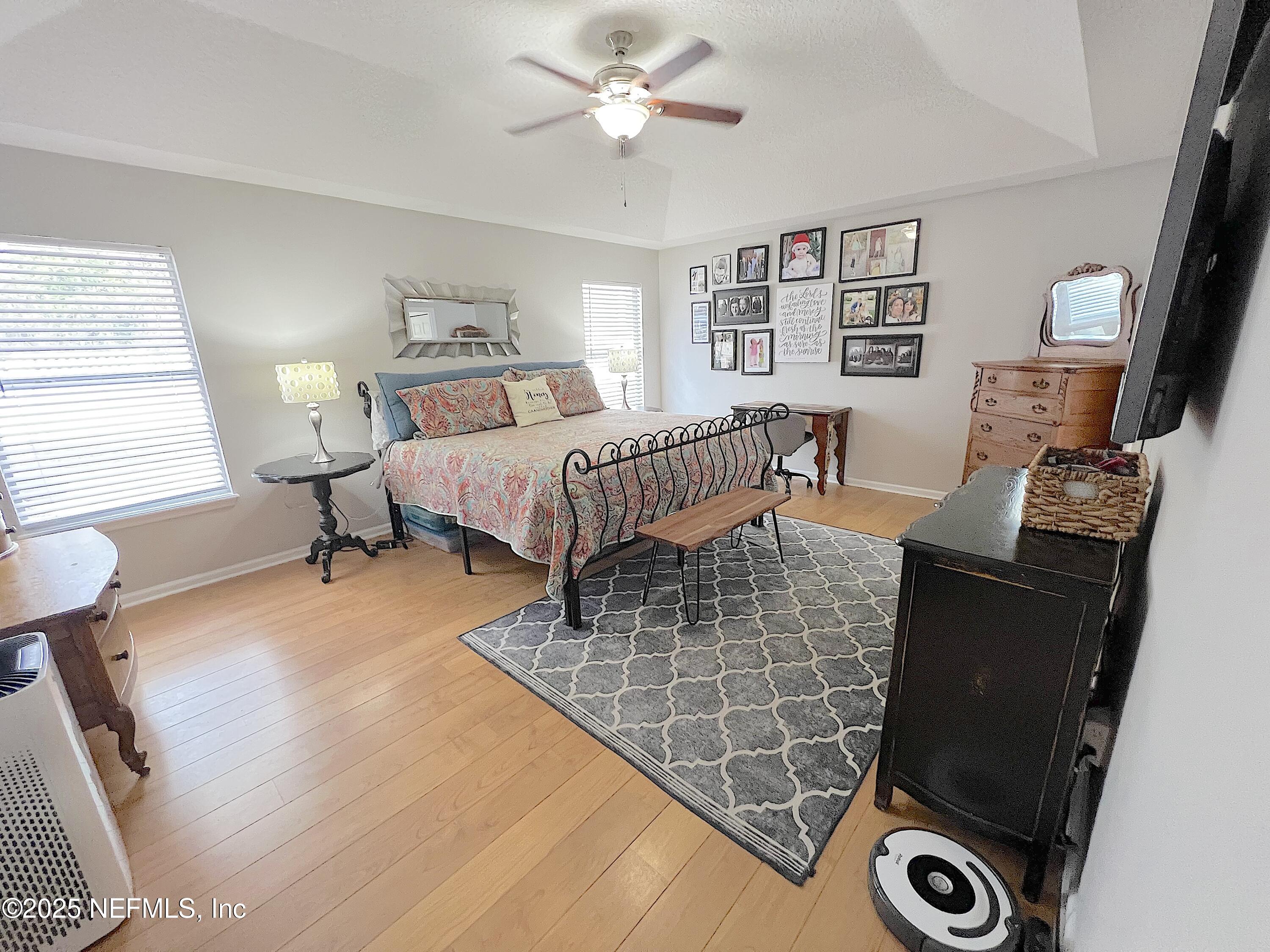 2020 Belle Grove Trace Fleming Island, FL 32003 - Photo 14 of 31 a bedroom with a bed and a chandelier