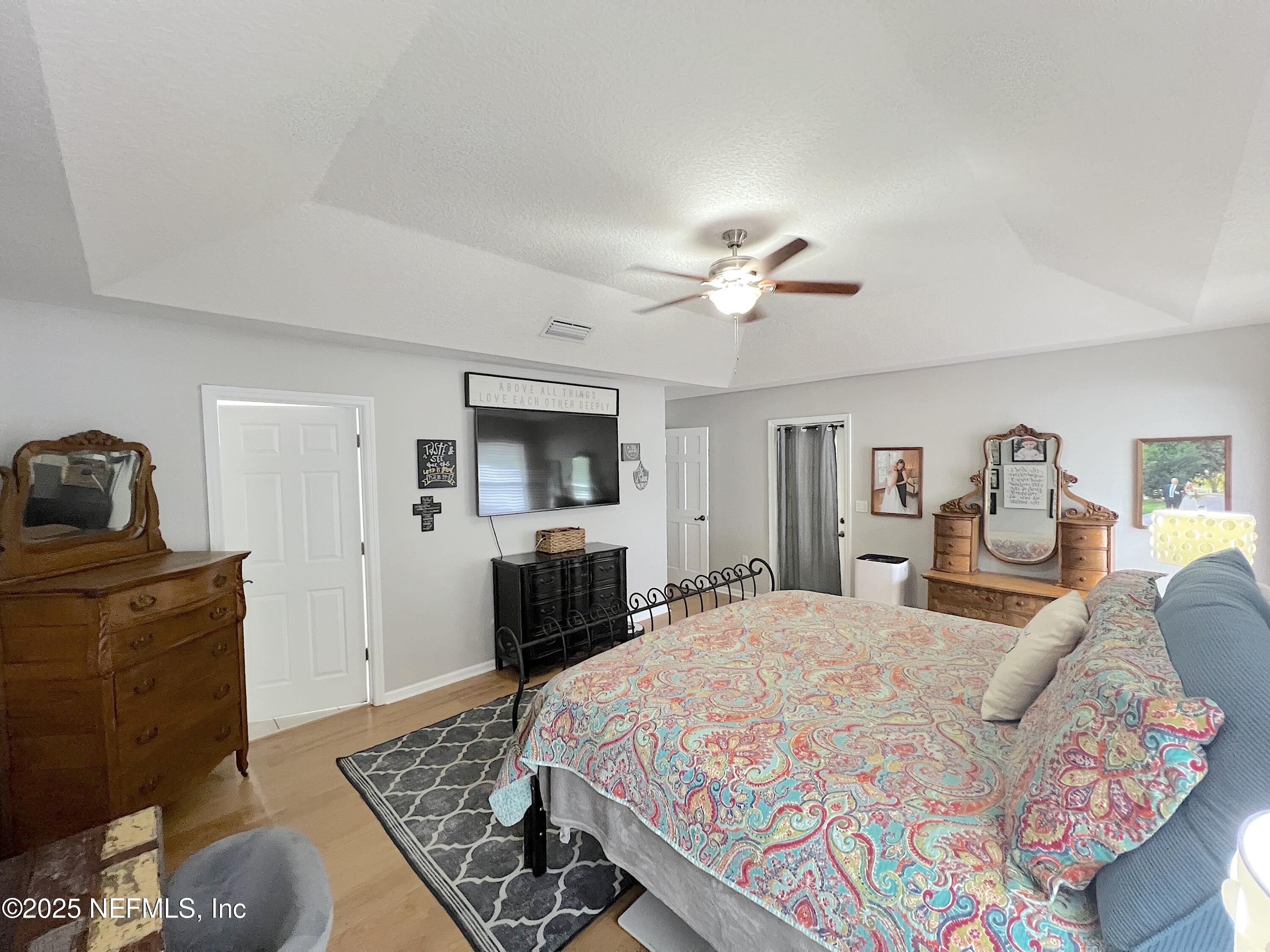 2020 Belle Grove Trace Fleming Island, FL 32003 - Photo 17 of 31 a bedroom with a bed and a television