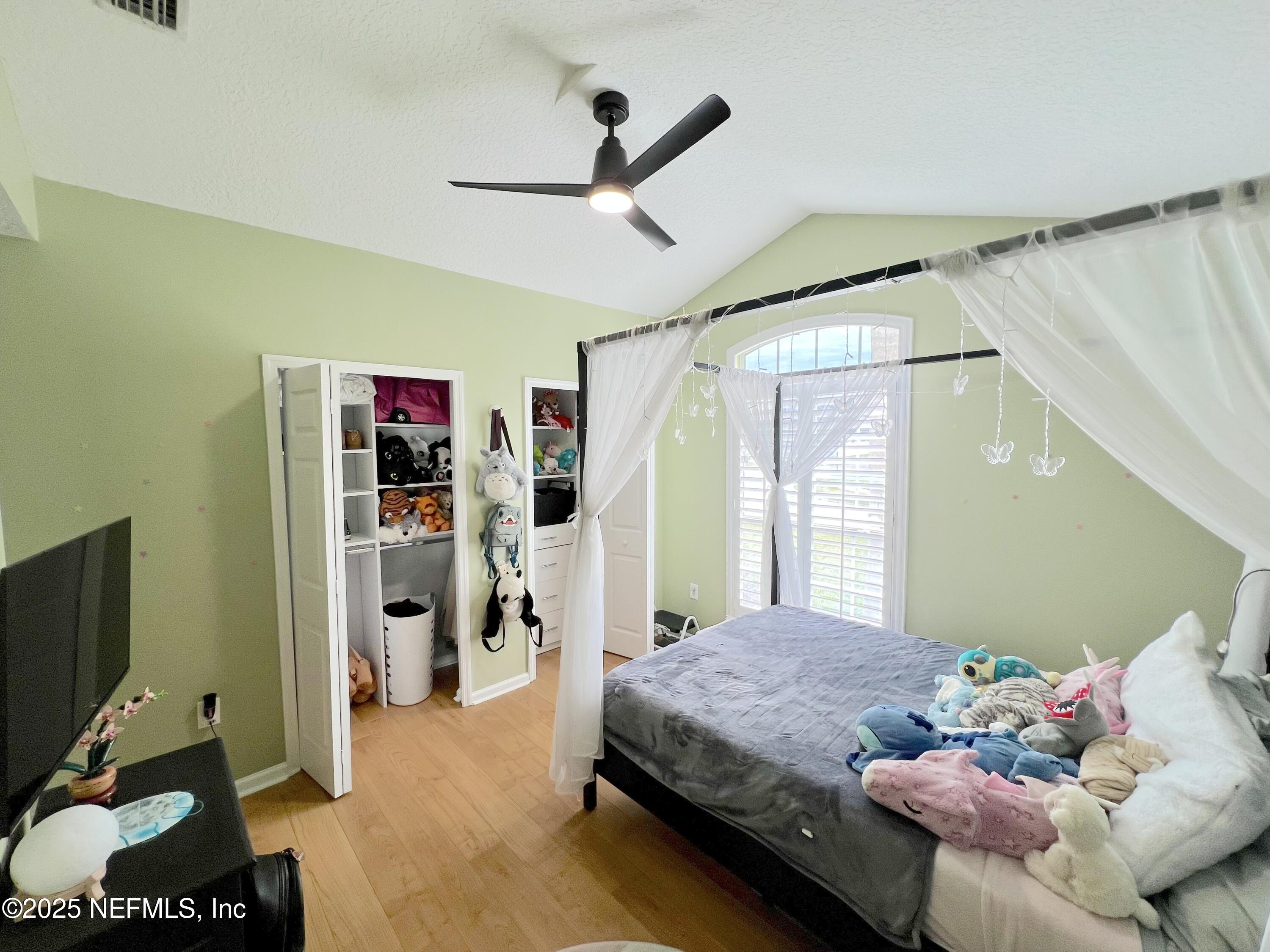 2020 Belle Grove Trace Fleming Island, FL 32003 - Photo 18 of 31 a bedroom with a bed couch and a window