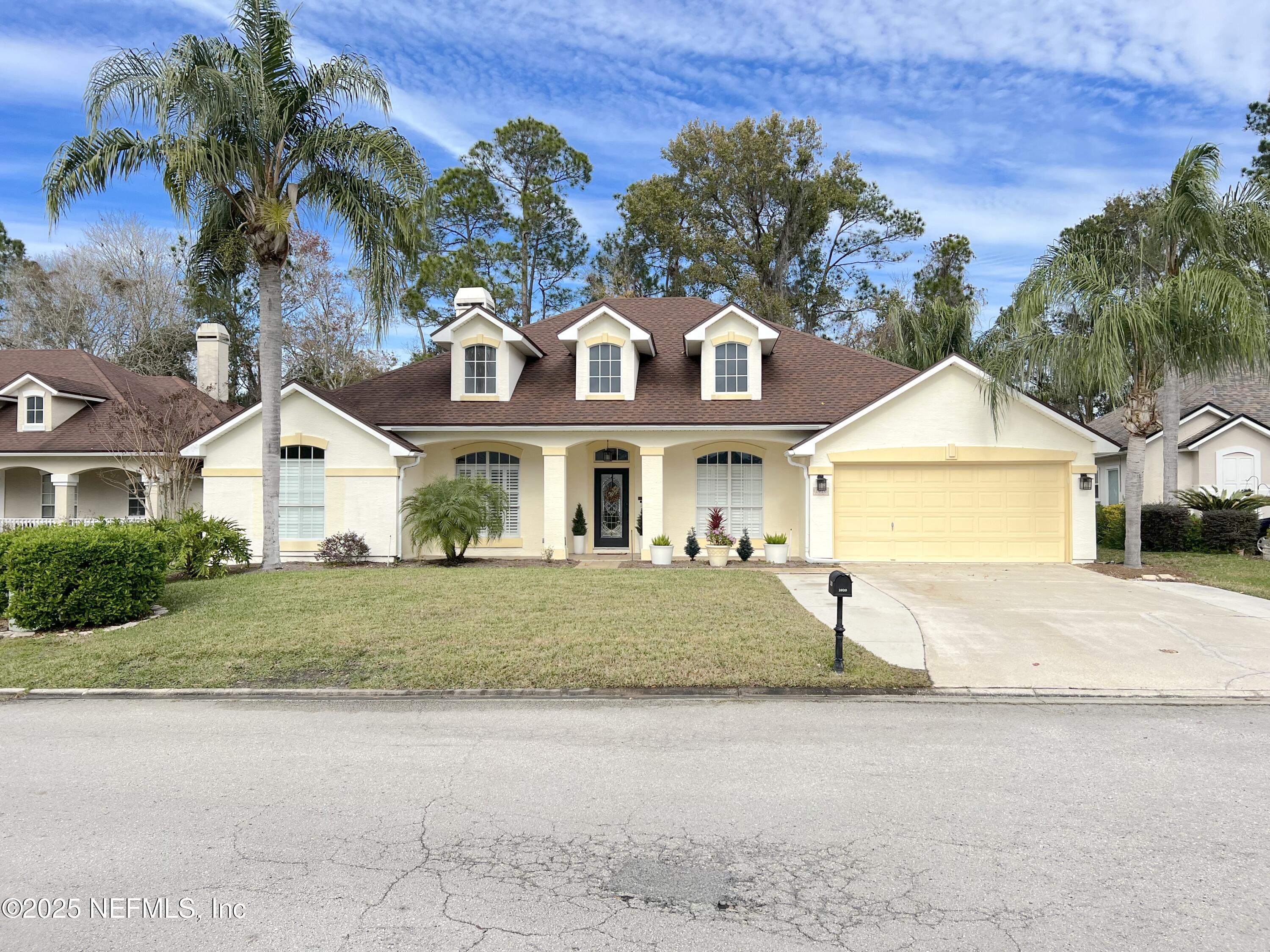 2020 Belle Grove Trace Fleming Island, FL 32003 - Photo 2 of 31 a front view of a house with a yard and garage