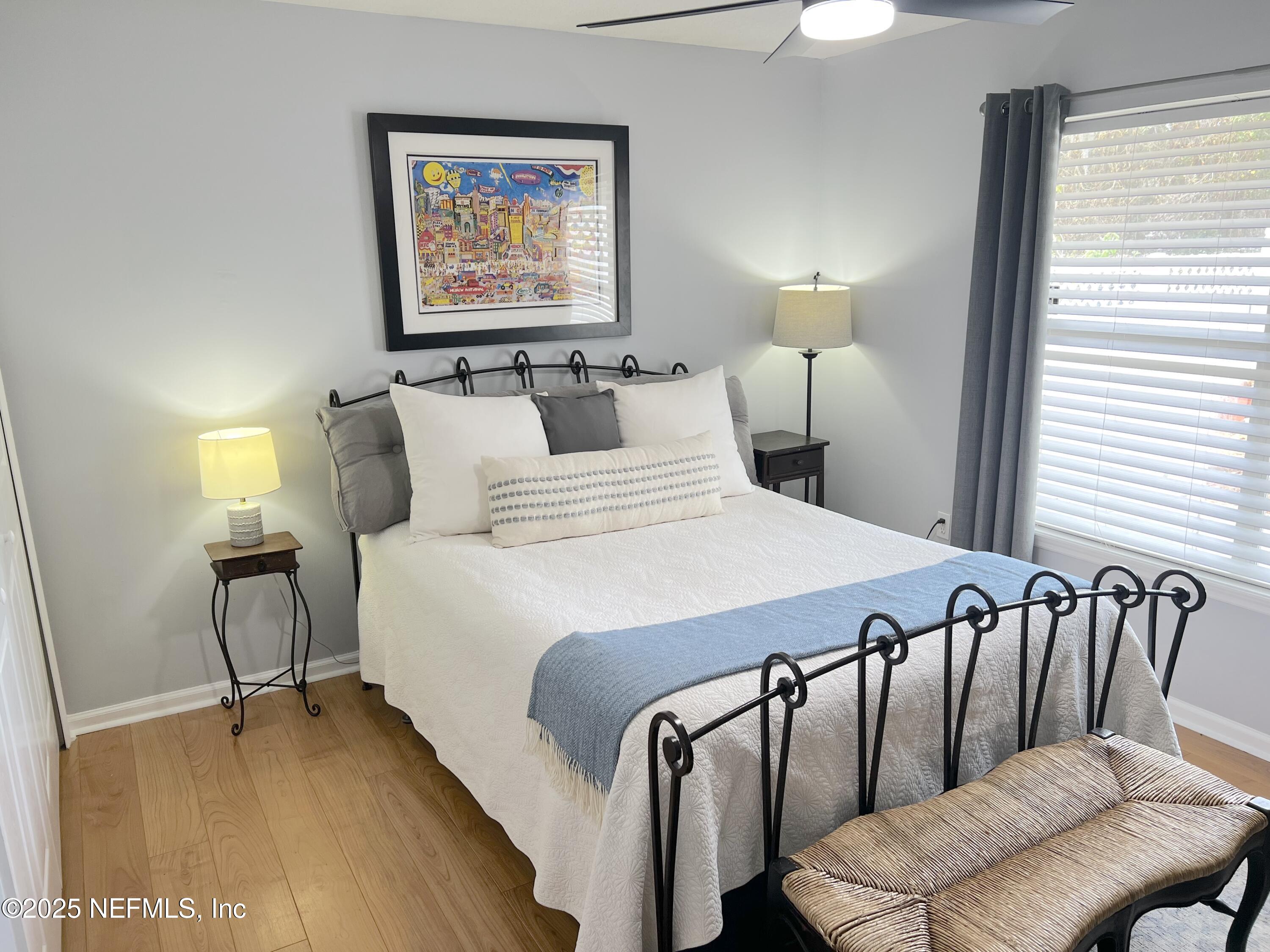 2020 Belle Grove Trace Fleming Island, FL 32003 - Photo 23 of 31 a bedroom with a bed and wooden floor