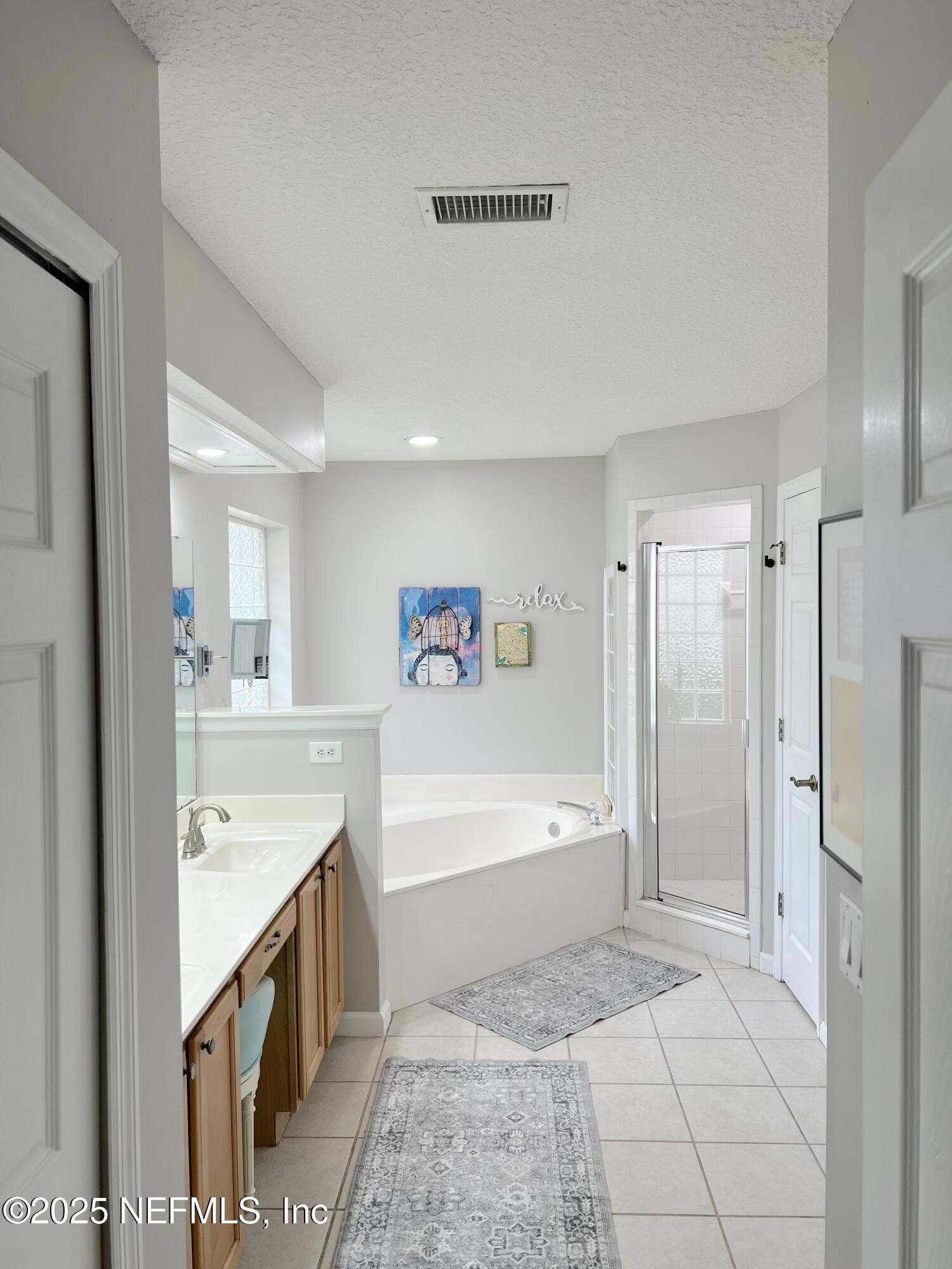 2020 Belle Grove Trace Fleming Island, FL 32003 - Photo 26 of 31 a spacious bathroom with a tub sink shower and a mirror