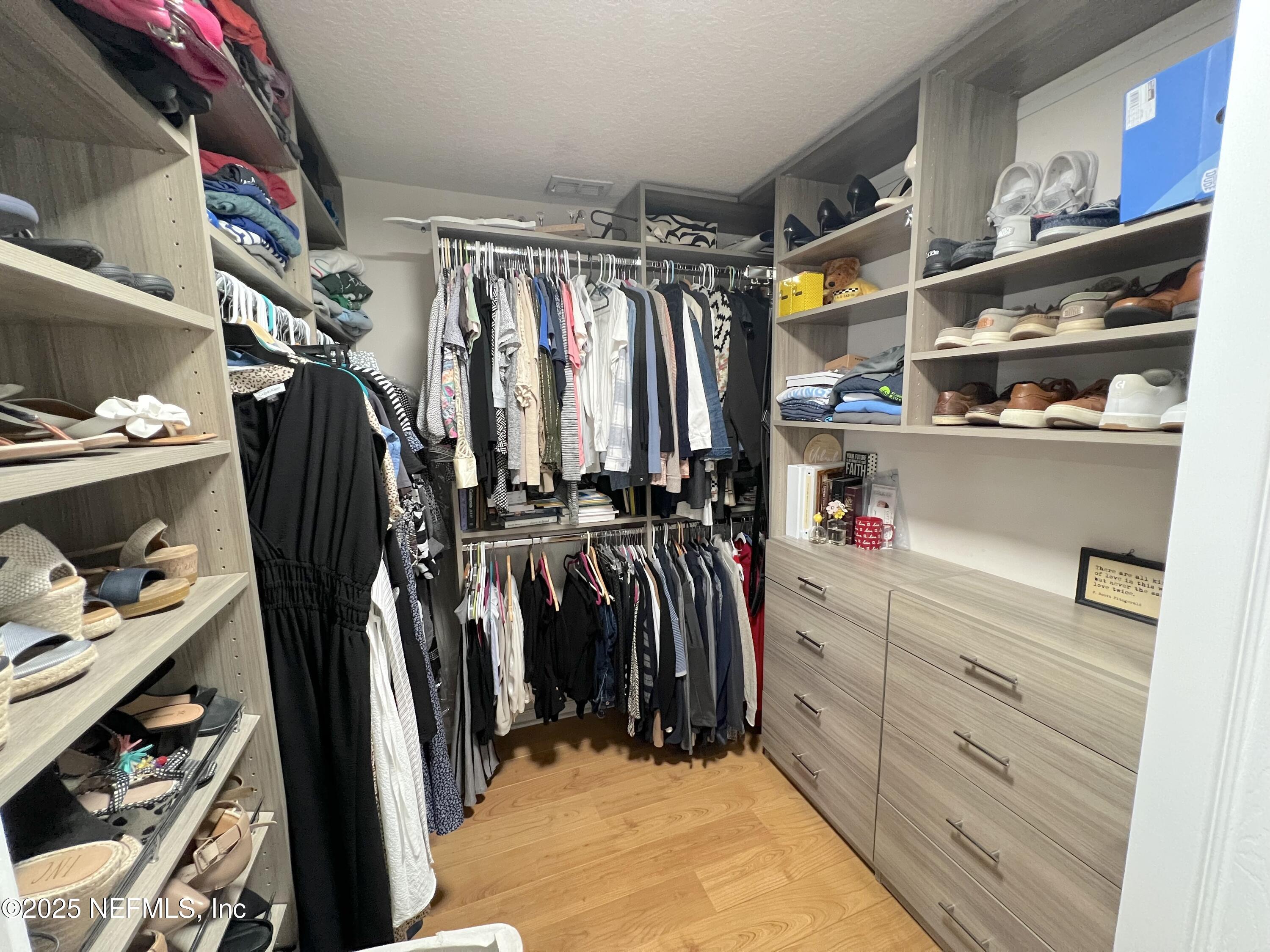 2020 Belle Grove Trace Fleming Island, FL 32003 - Photo 27 of 31 a view of walk in closet with clothes and shoes