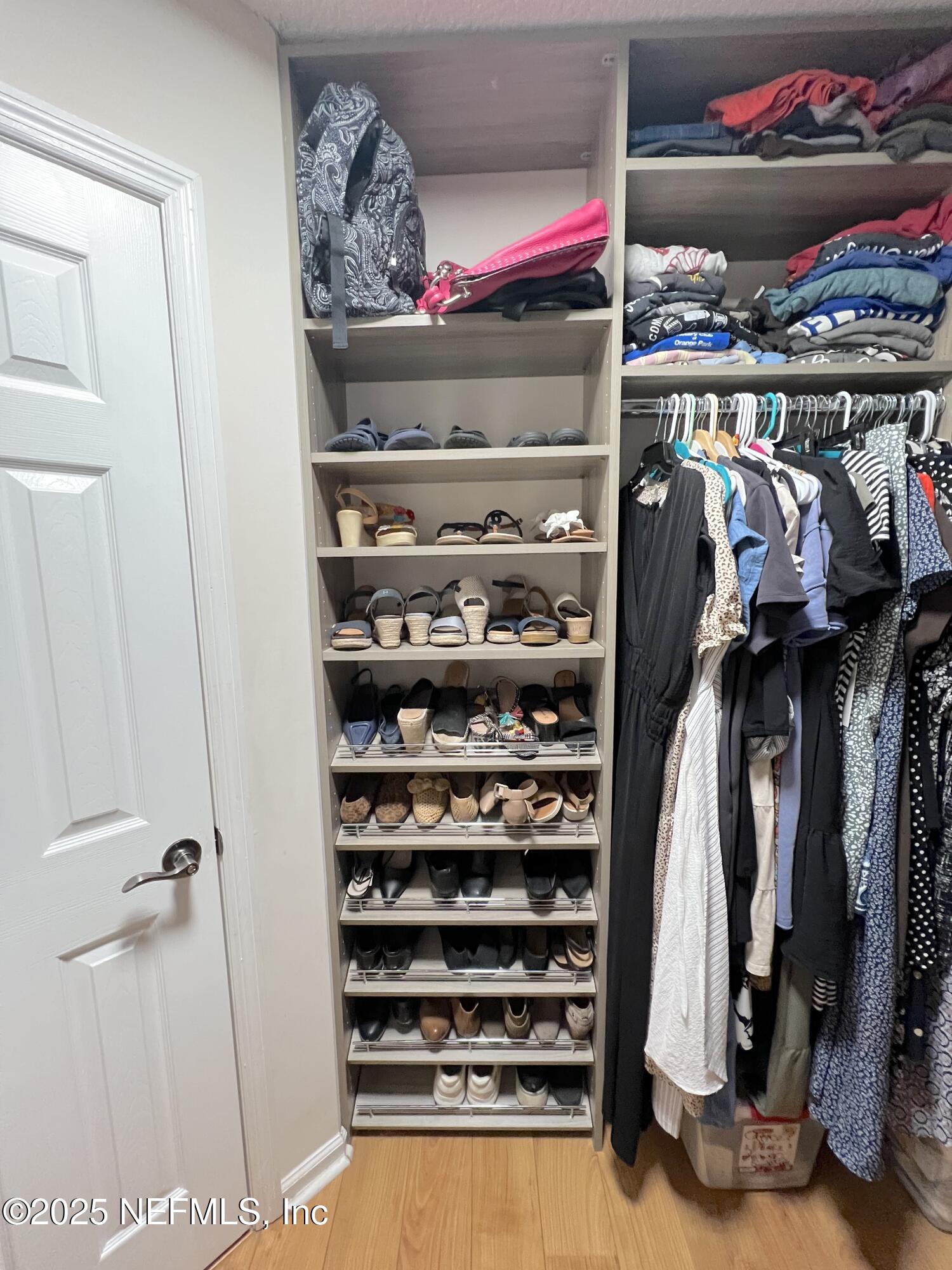 2020 Belle Grove Trace Fleming Island, FL 32003 - Photo 28 of 31 a view of walk in closet with clothes and shoes