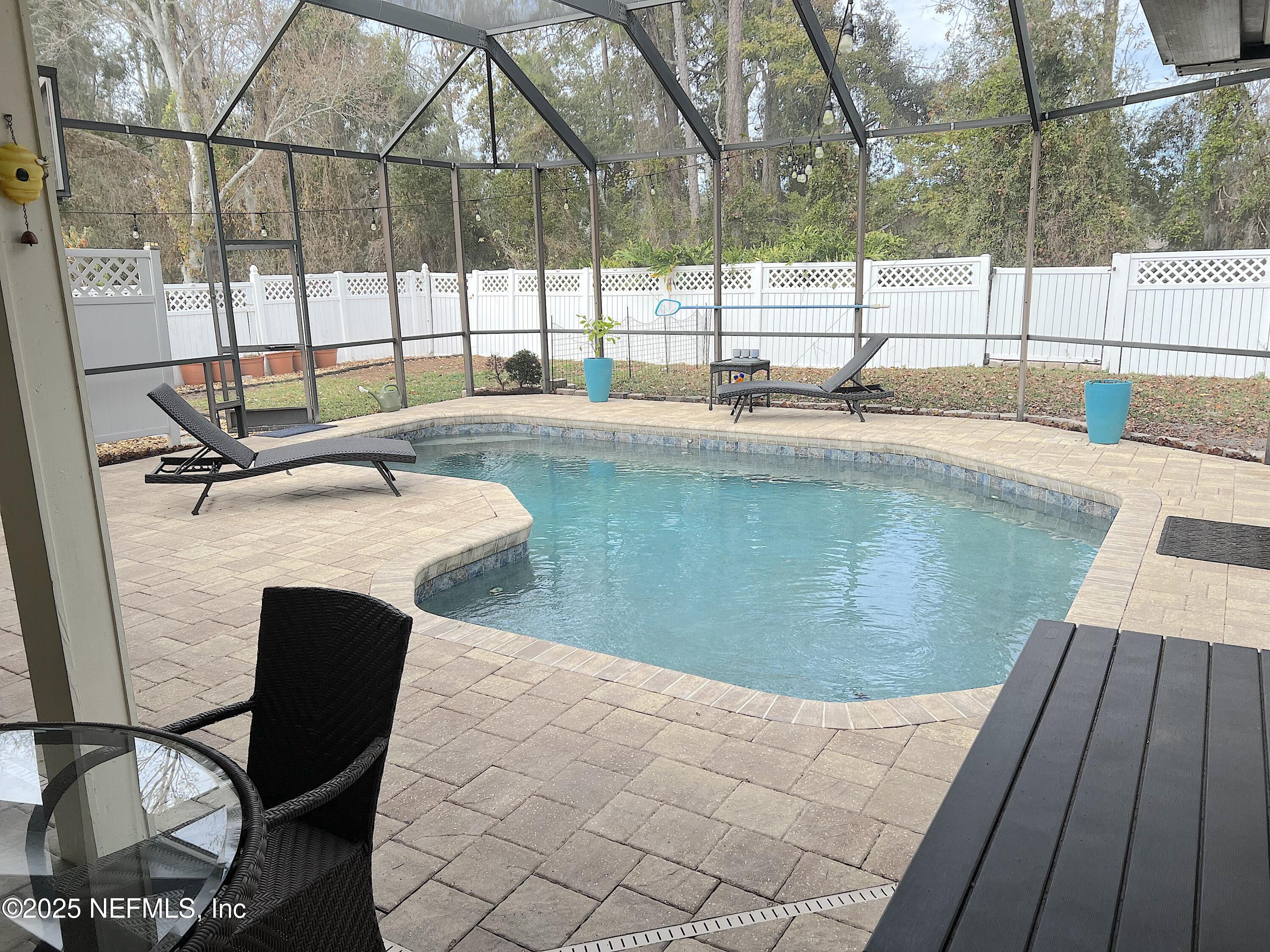 2020 Belle Grove Trace Fleming Island, FL 32003 - Photo 30 of 31 a view of a swimming pool with a lounge chair