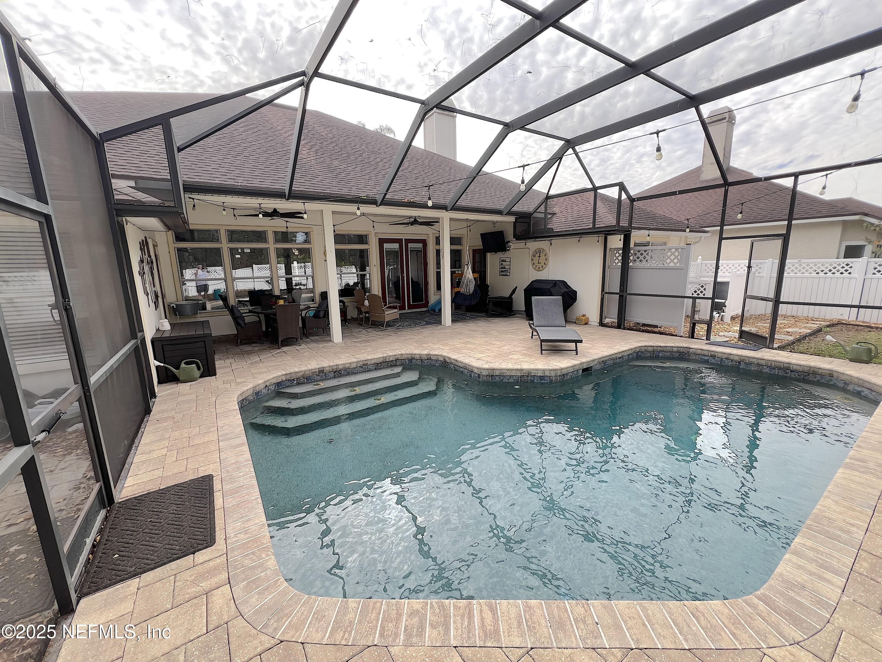 2020 Belle Grove Trace Fleming Island, FL 32003 - Photo 31 of 31 a view of a swimming pool with sitting area