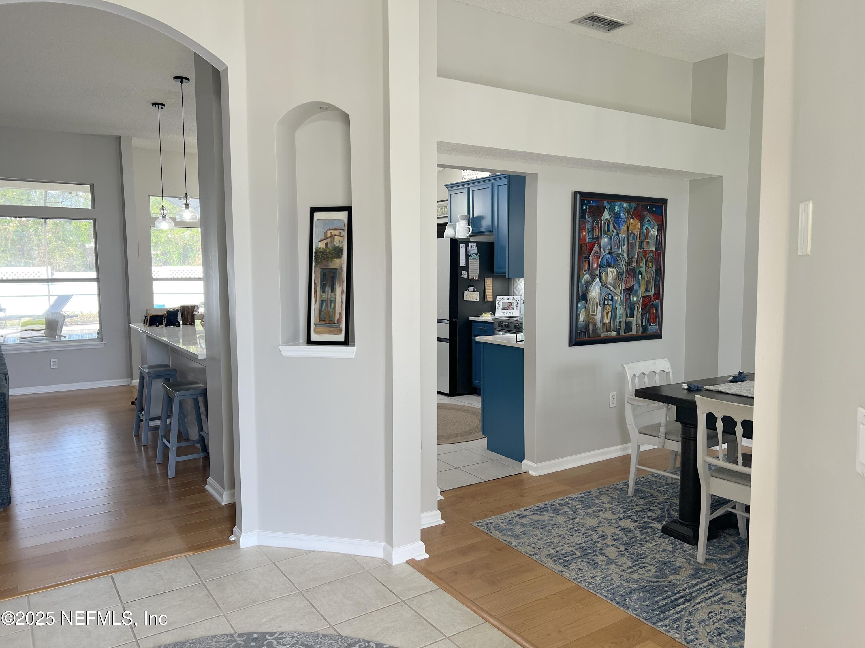 2020 Belle Grove Trace Fleming Island, FL 32003 - Photo 4 of 31 a view of a hallway to a livingroom and a dining room with furniture