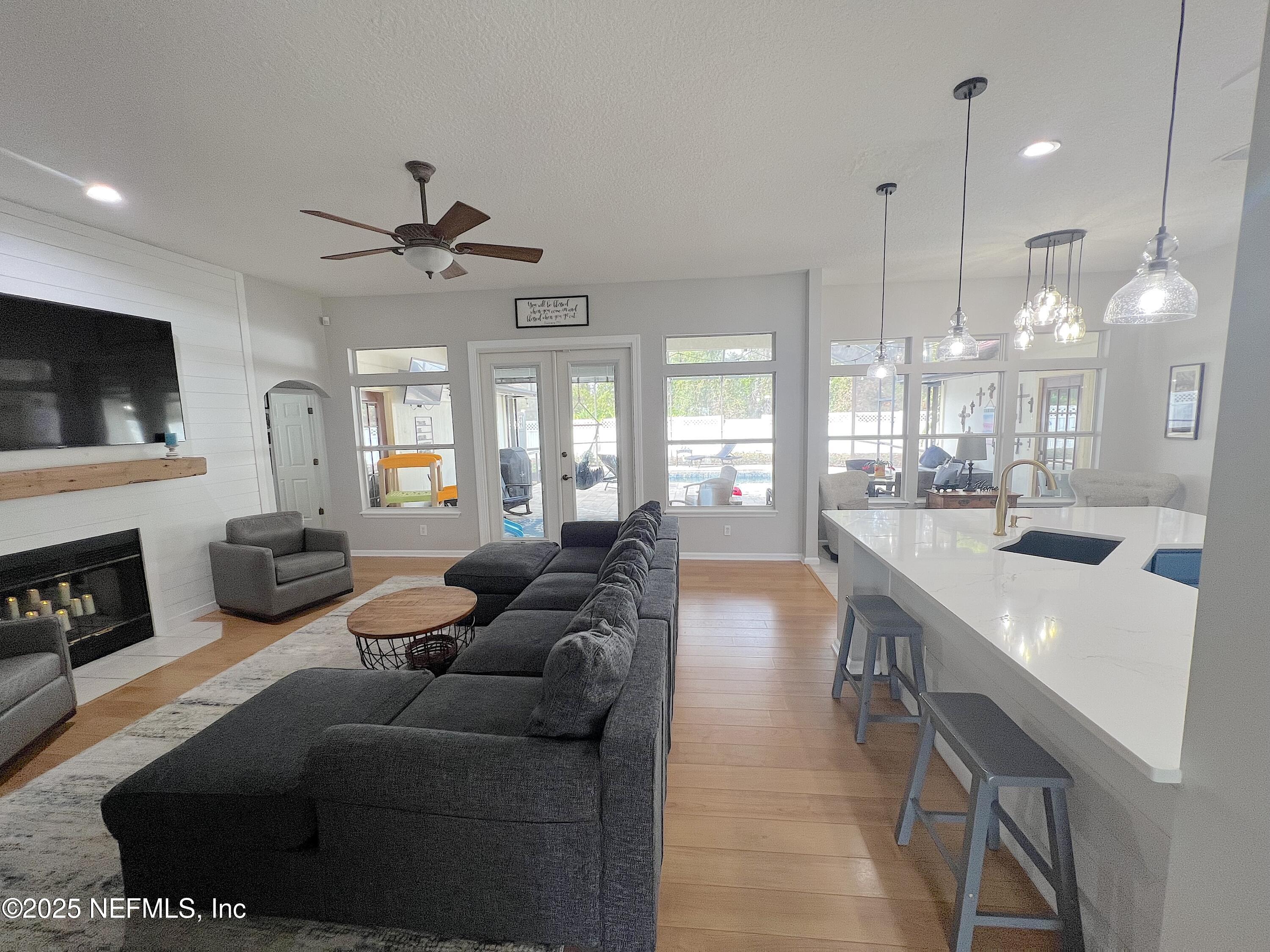 2020 Belle Grove Trace Fleming Island, FL 32003 - Photo 9 of 31 a living room with fireplace furniture and a flat screen tv