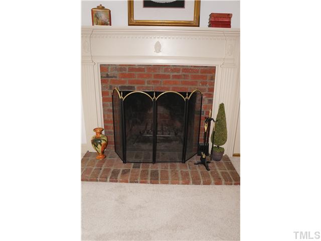 8444 Wycombe Lane Raleigh, NC 27615 - Photo 6 of 25 Masonry wood burning fireplace and elegant custom mantle. What a beautiful anchor to this room.