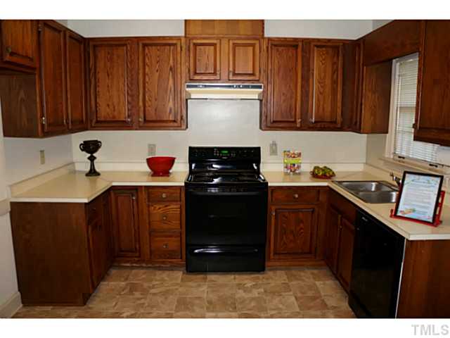 8444 Wycombe Lane Raleigh, NC 27615 - Photo 8 of 25 Custom solid wood cabinets add richness to this large chef-like kitchen with great counter space.