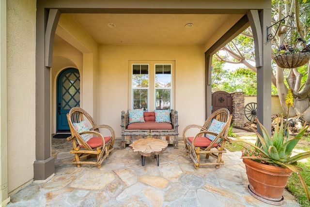 a living room with furniture a fireplace and a large window