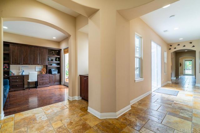 a view of a dining room with furniture wooden floor and chandelier
