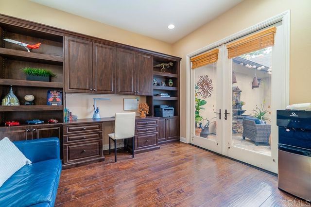a kitchen with a sink a counter top space appliances and cabinets