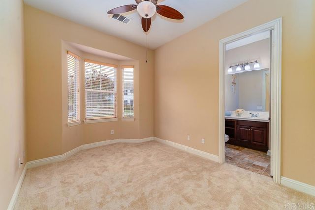 a kitchen with stainless steel appliances granite countertop a sink a stove and a wooden cabinets