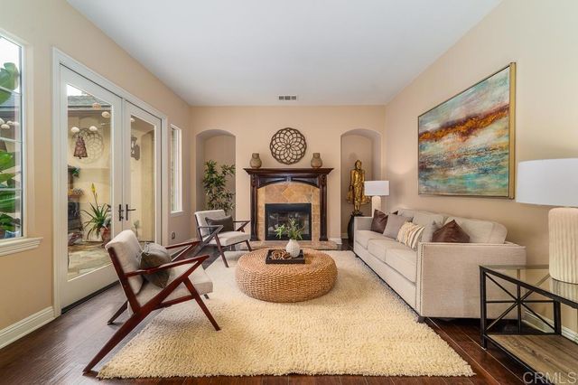 a bedroom with furniture and a large window