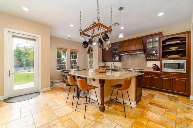 a view of a swimming pool with a table and chairs under an umbrella