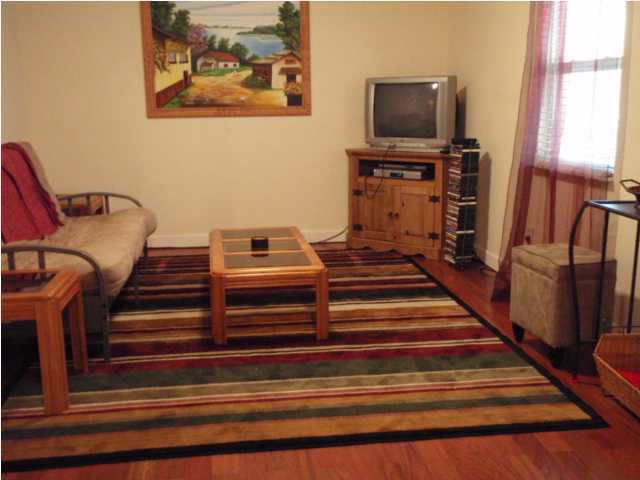 435 West Nursery Road Santa Rosa Beach, FL 32459 - Photo 3 of 10 a living room with furniture and a flat screen tv