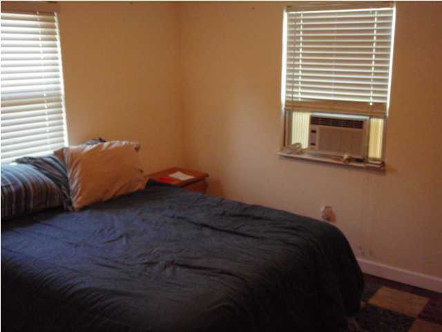 435 West Nursery Road Santa Rosa Beach, FL 32459 - Photo 8 of 10 a bed sitting in a bedroom next to a window