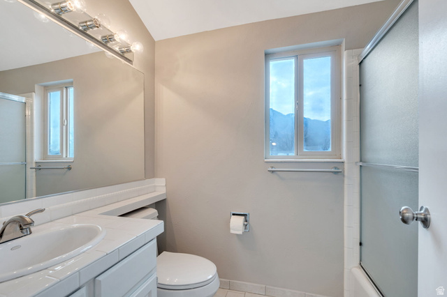 3221 North Shadowbrook Circle Provo, UT 84604 - Photo 18 of 29 Bathroom featuring vanity, light tile patterned floors, plenty of natural light, and shower / bath combination with glass door