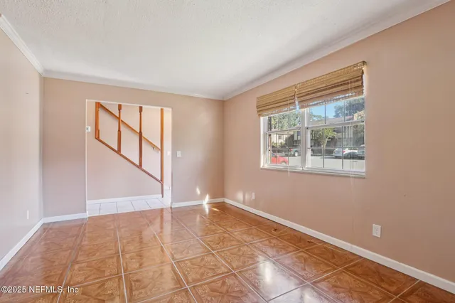 an empty room with windows and entrance