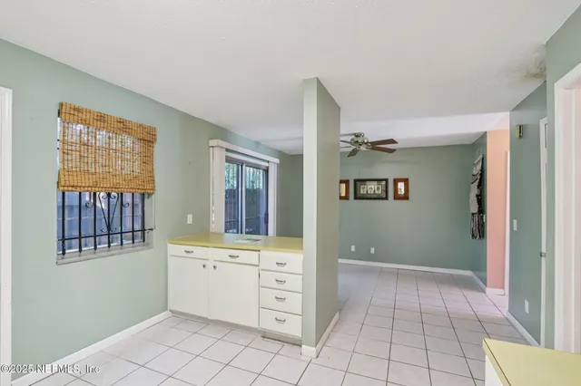 a view of an empty room with window and cabinet