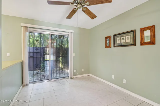 a spacious bedroom with a bed a dresser and large mirror