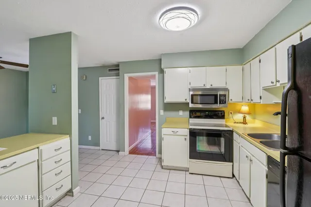a kitchen with stainless steel appliances a stove a refrigerator and cabinets