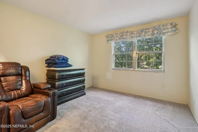 a view of staircase with white walls and a window