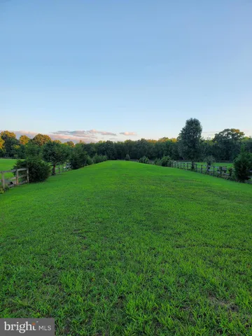 a view of a grassy field with mountain