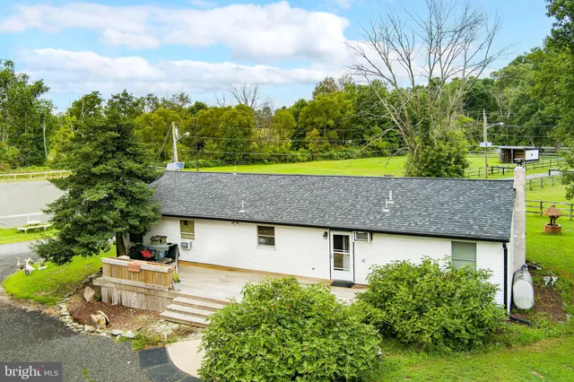 an aerial view of a house with yard swimming pool and outdoor seating