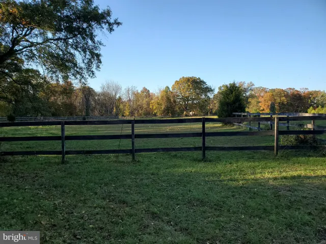 a view of a swimming pool with an outdoor seating and a yard