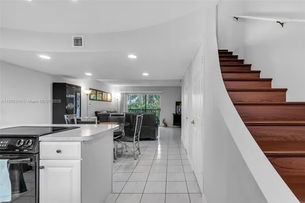 a view of a kitchen with fridge and workspace