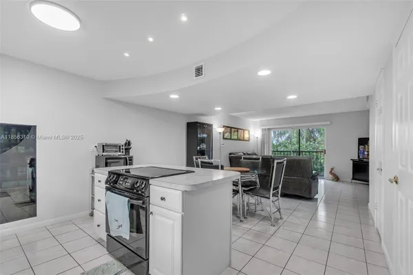 a kitchen with white cabinets appliances and a sink
