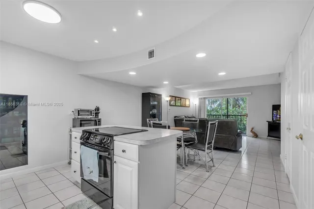 a kitchen with white cabinets appliances and a sink