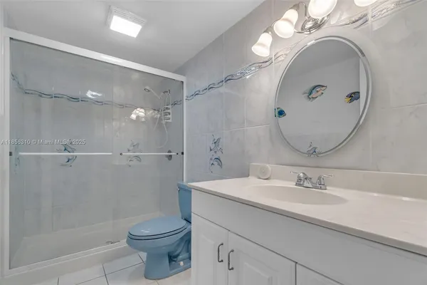 a kitchen with refrigerator and chairs