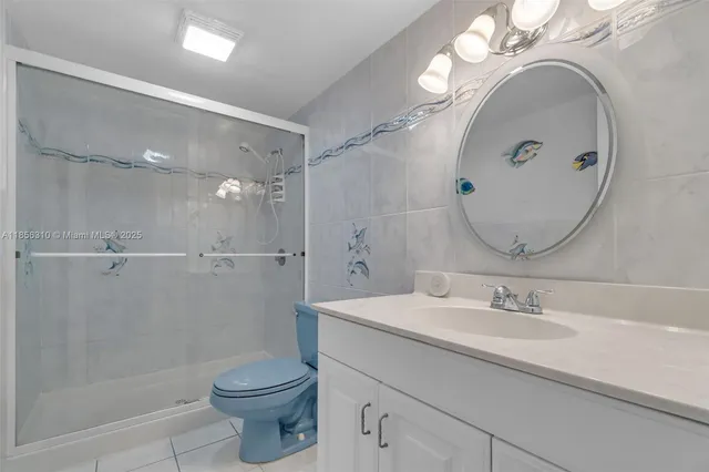 a kitchen with refrigerator and chairs