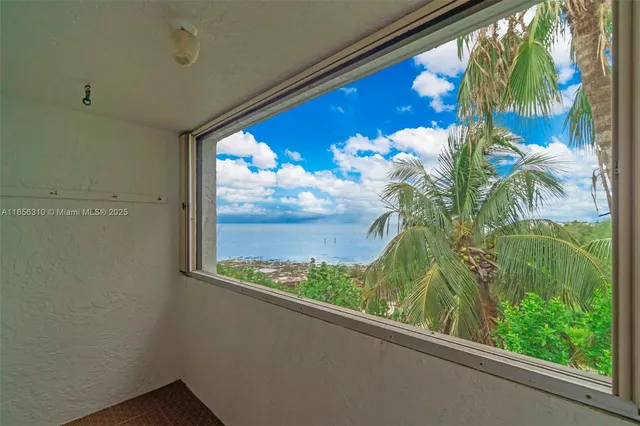 a view of a hallway to a livingroom with furniture