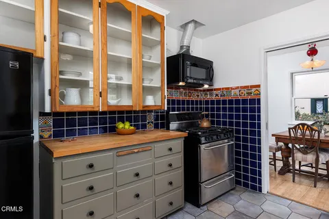 a kitchen with stainless steel appliances a stove and a microwave