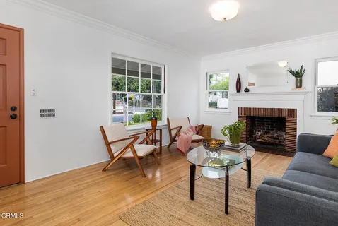 a living room with furniture a table and a fireplace