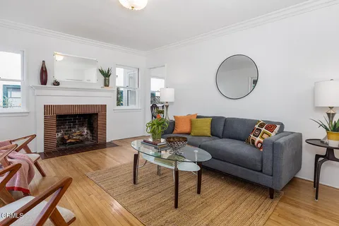 a living room with furniture a fireplace with wooden floor