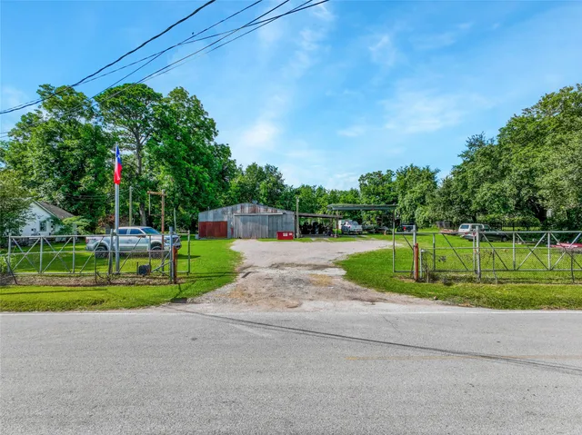 a view of a swimming pool with a yard and palm trees
