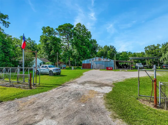 a view of backyard with wooden fence