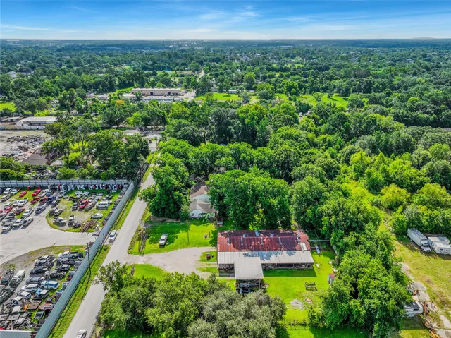 an aerial view of residential houses with outdoor space and swimming pool