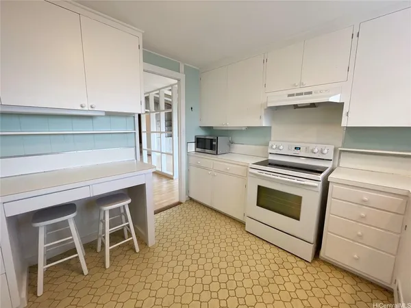 a kitchen with a refrigerator a sink and a stove