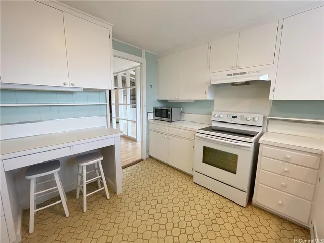 a kitchen with a refrigerator a sink and a stove