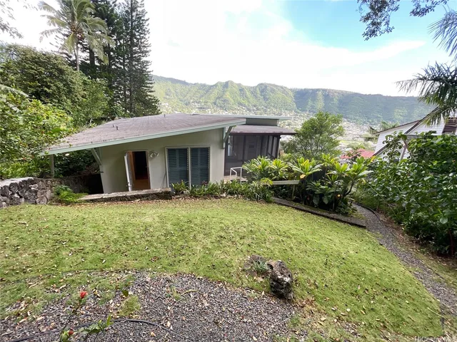 a front view of house with yard and green space