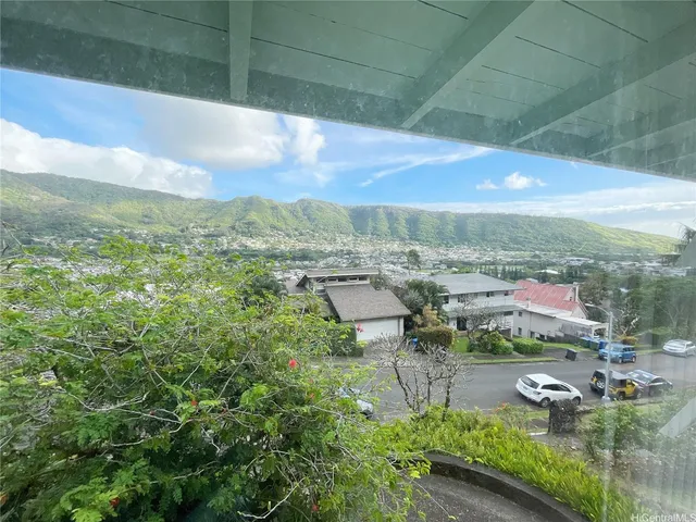 a view of a glass door and a yard from a window