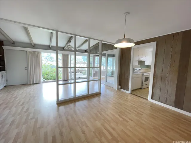 a view of room with furniture and a large window